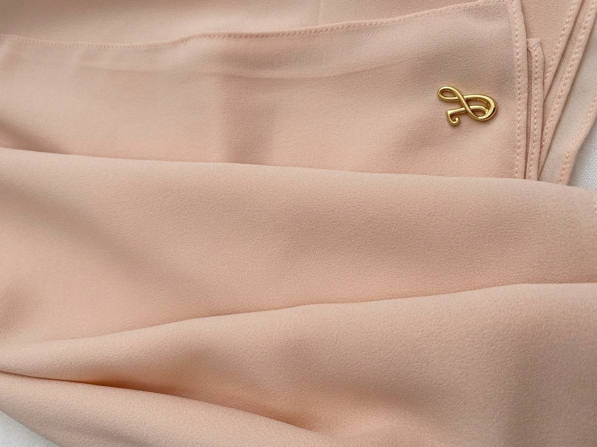Soft blush pink premium chiffon hijab fabric close-up showing light texture and drape