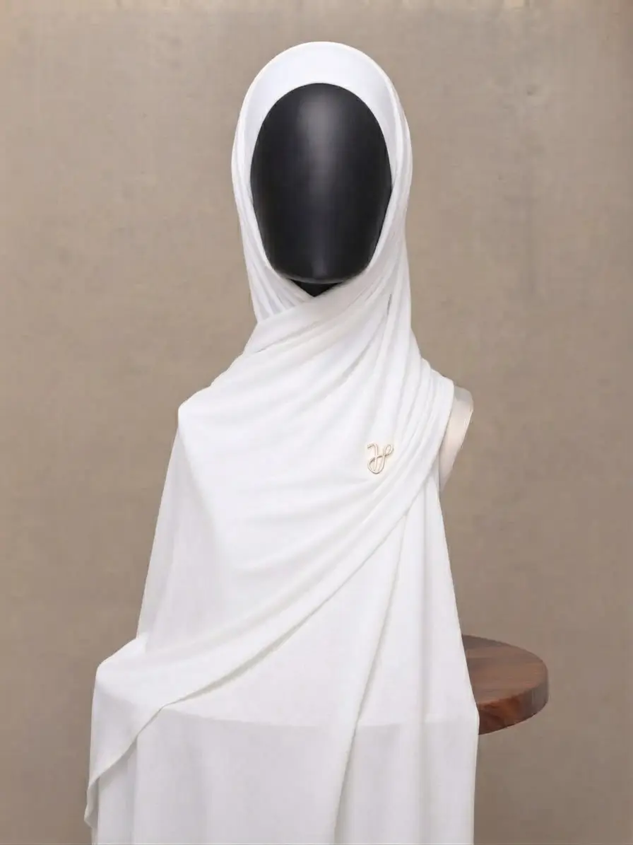 Crisp white premium cotton jersey hijab with signature gold charm