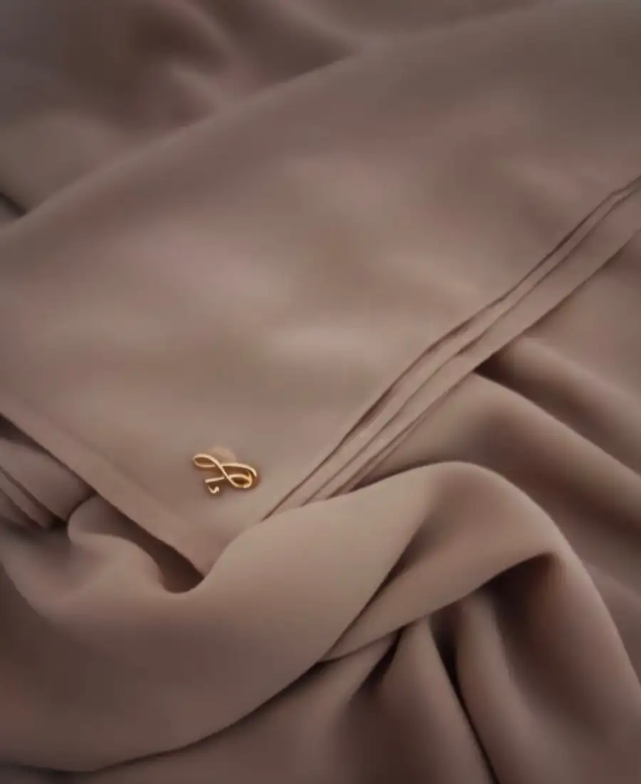 Warm hazelnut golden brown neutral premium chiffon hijab with signature gold charm