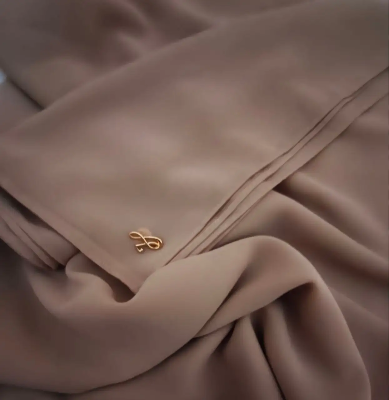 Warm hazelnut golden brown neutral premium chiffon hijab with signature gold charm