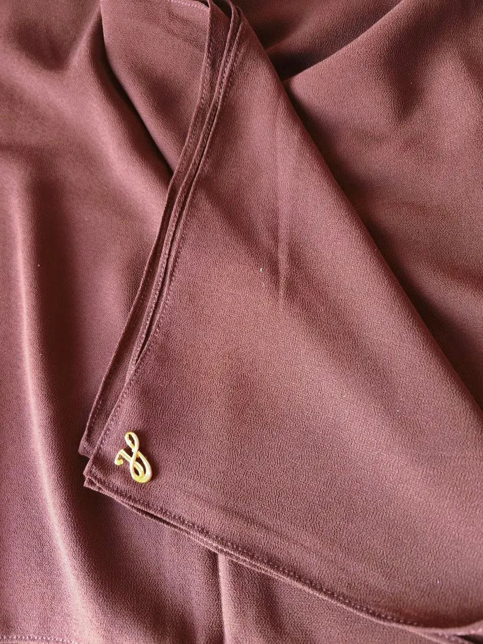 Warm terracotta earthy brown red premium chiffon hijab with signature gold charm
