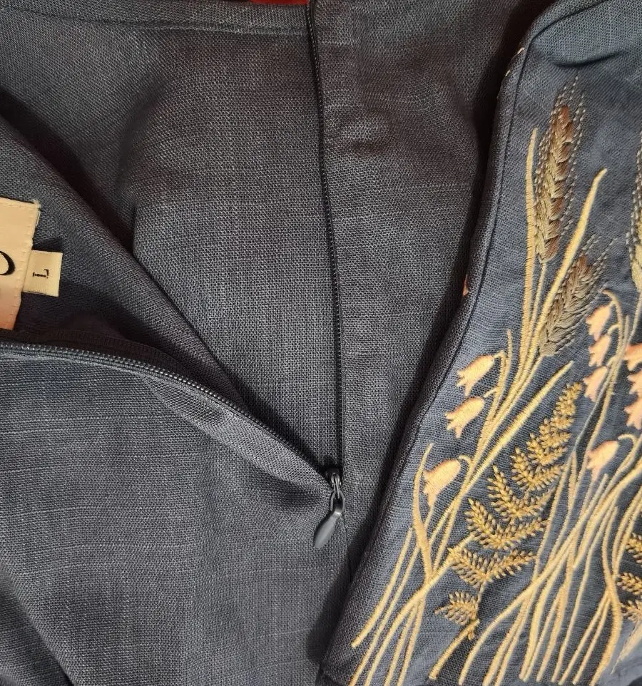 Detailed view of a blue linen-viscose muslim dress featuring intricate floral embroidery around the cuffs.